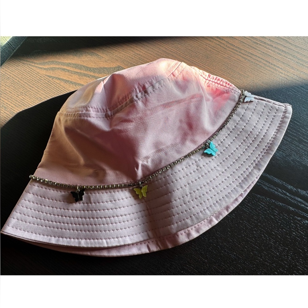 Pink bucket hat with butterfly chain